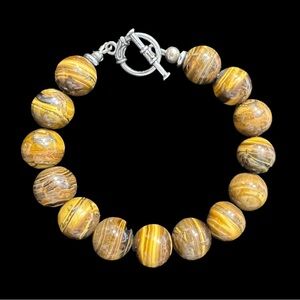 MENS TIGER EYE BRACELET WITH SILVER PLATED CLASP. MEASURES 9 1/2 INCHS LONG.